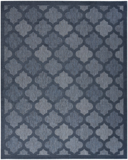 Navy blue rug with a repeating light-blue trellis pattern and a textured woven surface.