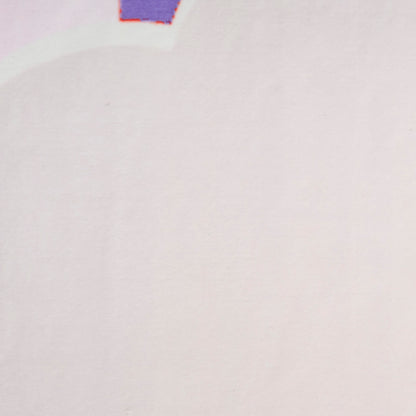 Soft pale pink fabric surface with a tiny purple tag edged in orange at the top center.