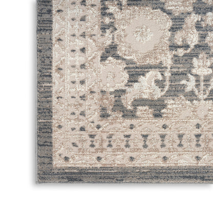 Beige & gray distressed oriental area rug corner with ornate floral border, plush pile, neutral tones
