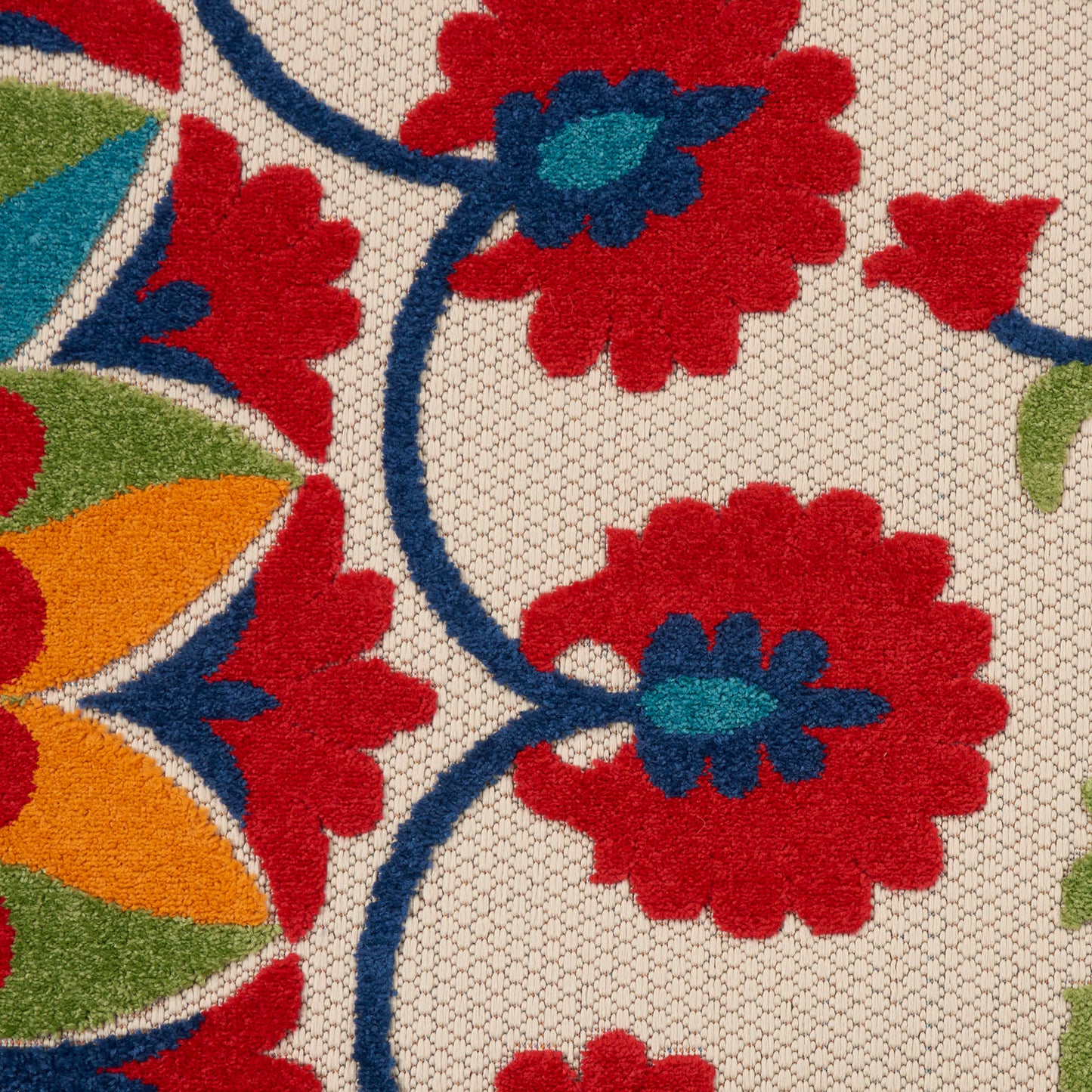 Floral round rug with red blossoms, blue stems, green leaves and orange accents on a beige honeycomb background.
