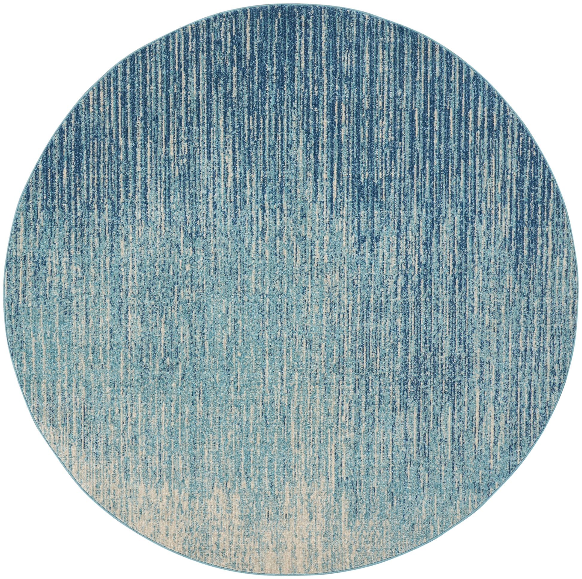 Round rug with blue gradient and vertical stripe texture, navy to beige ombre.