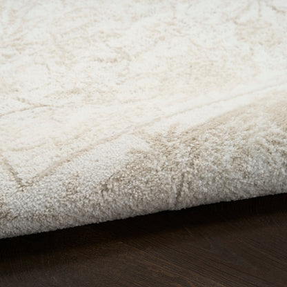Cream shag rug with dense plush pile and subtle geometric pattern, folded edge resting on dark wooden floor.