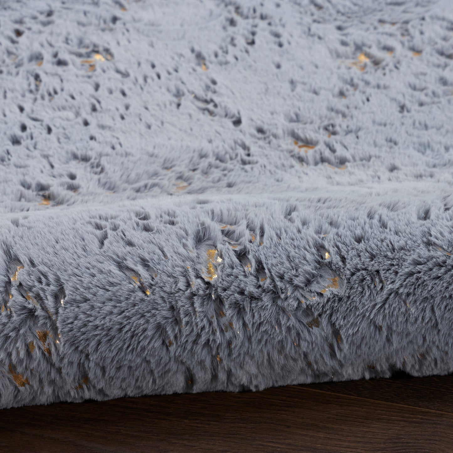 Soft gray plush shag rug with gold fleck accents; luxurious faux fur texture for cozy living spaces.