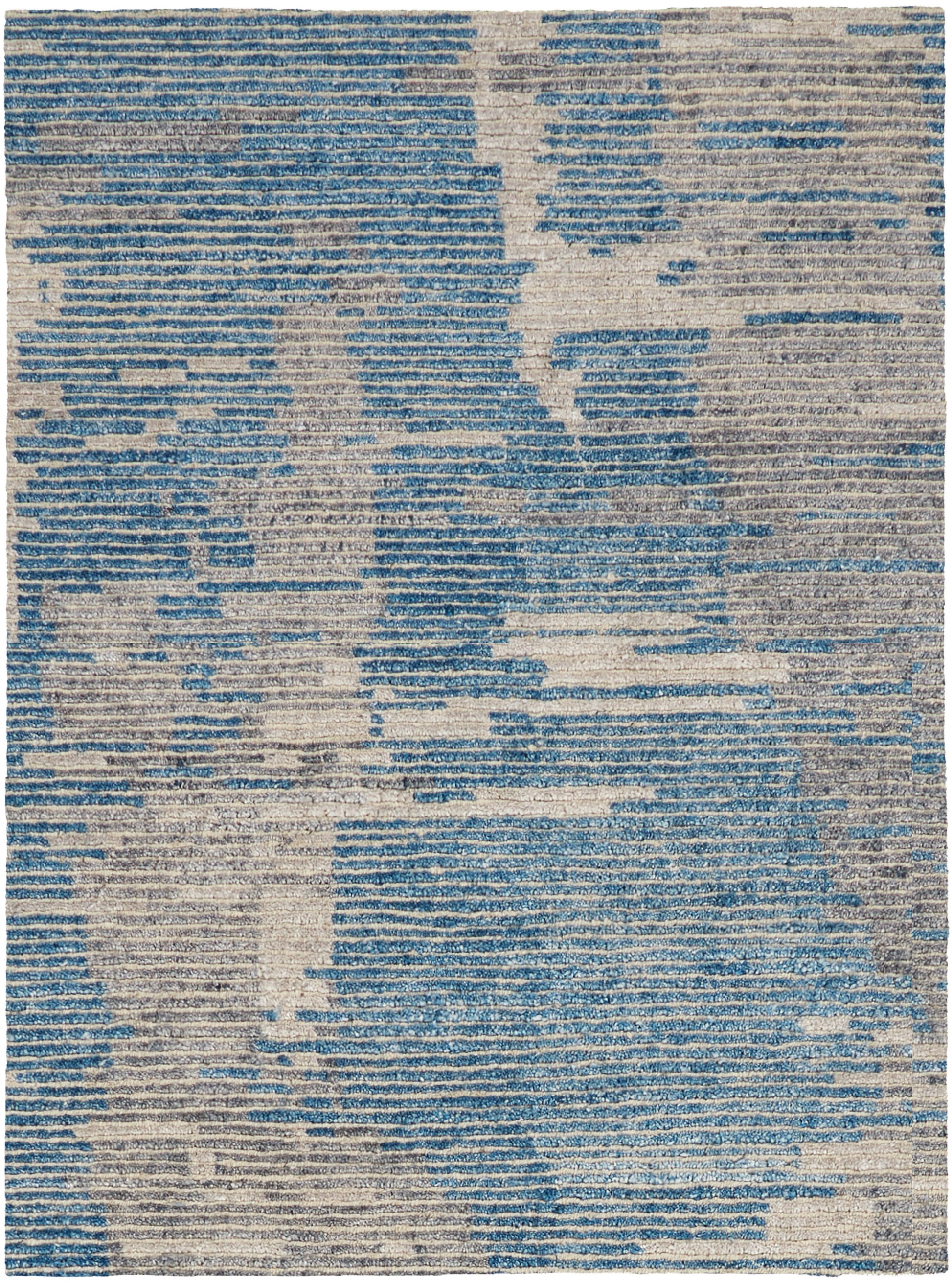 Rectangular area rug featuring an abstract blue and beige distressed pattern; modern woven texture.