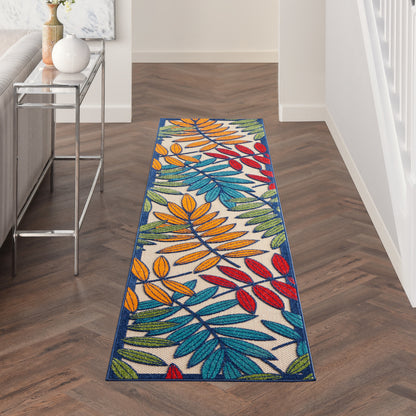 Colorful tropical leaf-pattern runner rug with blue, orange, yellow, red leaves on white, navy edge in hallway.