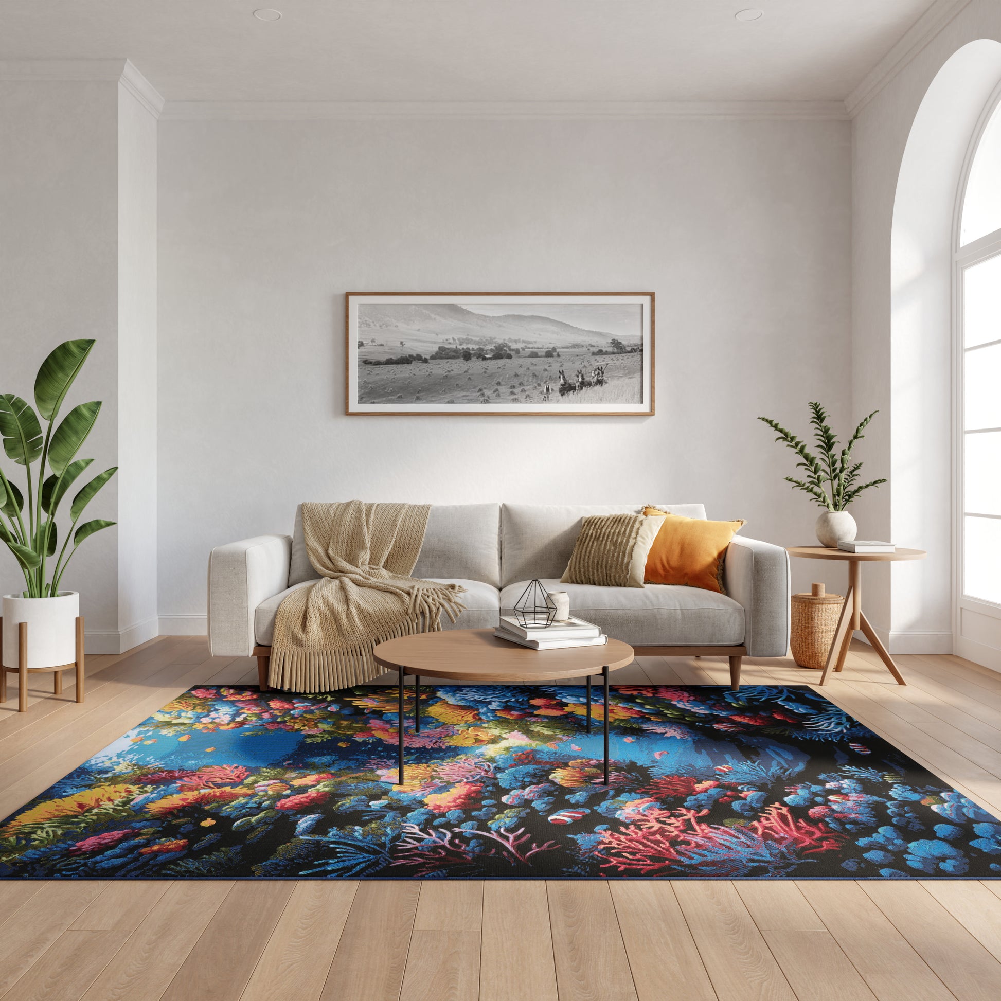 Cozy living room with neutral sofa, beige throw, colorful rug, round wood coffee table, plants, arched window, landscape art.
