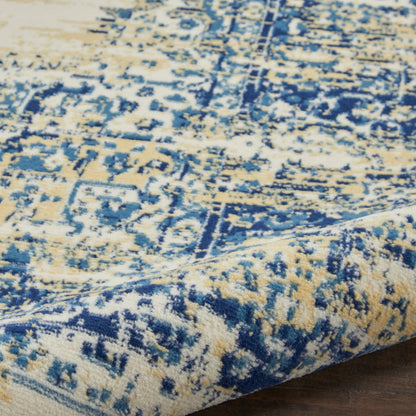 Close-up of a blue and beige distressed oriental rug with a rolled edge on a wooden floor.