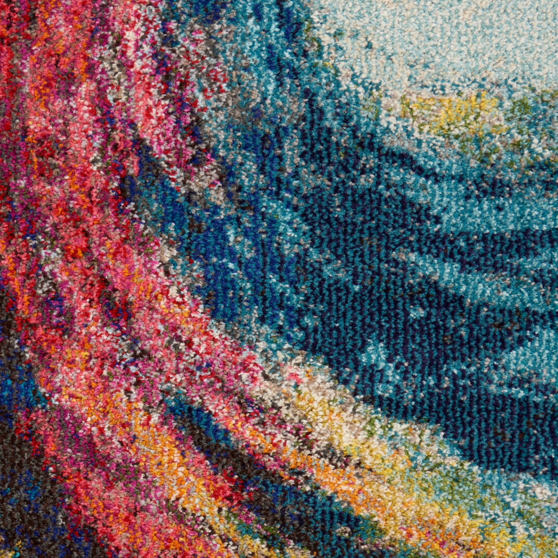 Close-up of a vibrant multicolor woven rug with an abstract swirling pattern and looped pile texture.