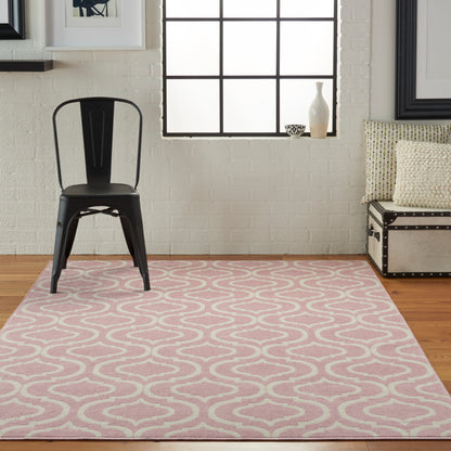 Industrial black metal chair on a pink rug with white interlocking waves in a bright brick-wall living room.