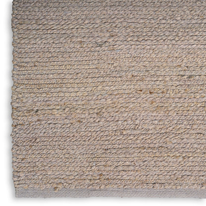Beige loop-pile rug in natural fiber with subtle texture and light gray edge.