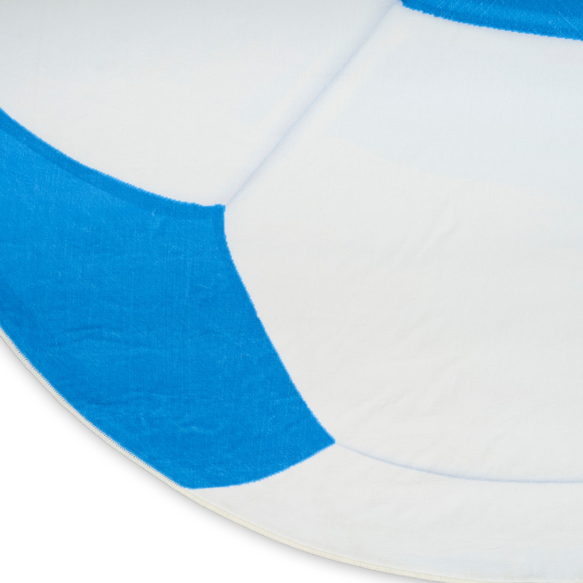 Round rug with blue and white color-blocked segments, plush pile, modern geometric design.