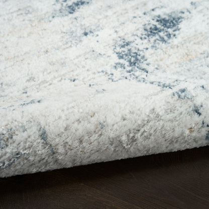 Soft white and pale blue plush shag rug with a high pile on dark wood floor.