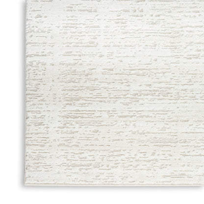 Ivory textured area rug with subtle beige brushed pattern; soft woven surface for modern living spaces.
