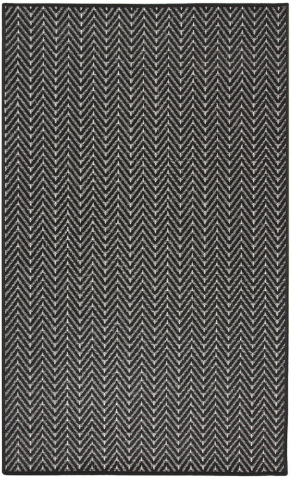 Rectangular black and white chevron rug with textured woven pattern for modern decor.