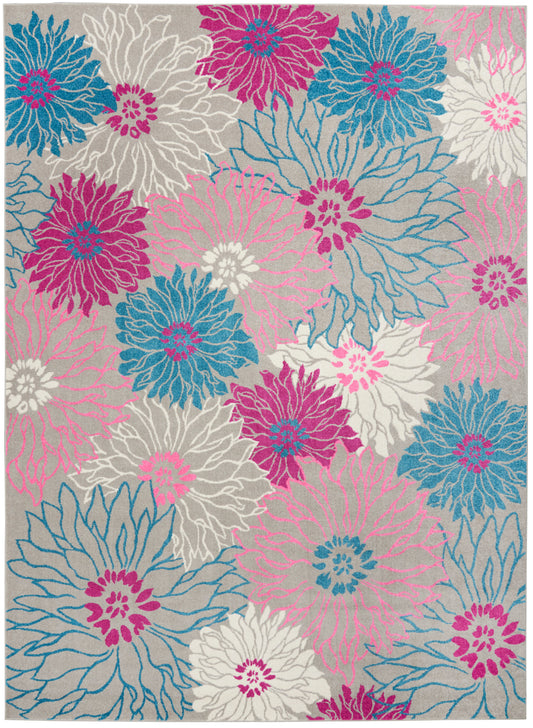 Colorful area rug with oversized pink, magenta, teal blue and white flowers on a light gray background.
