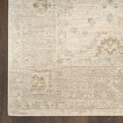 Beige distressed oriental area rug with subtle floral patterns on dark wood floor.