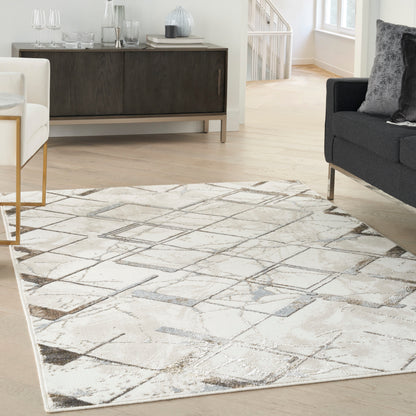 Neutral area rug with abstract geometric pattern in beige, gray and ivory on light wood floor in a modern living room.