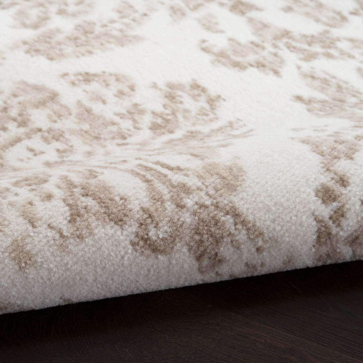 Rectangular cream rug with beige abstract pattern, soft plush pile, ideal for living room decor.