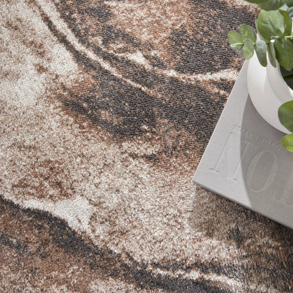 Earth-toned marble-pattern rug in beige and brown with a light gray decorative block and a white plant pot with green leaves.