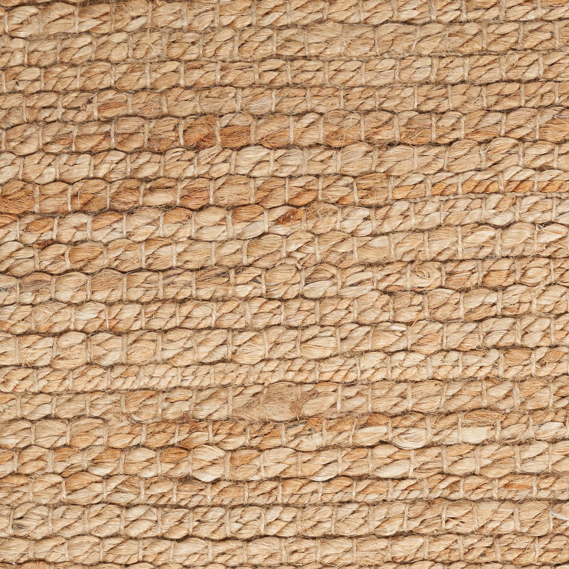 Natural beige jute rope weave close-up, rustic rug texture.
