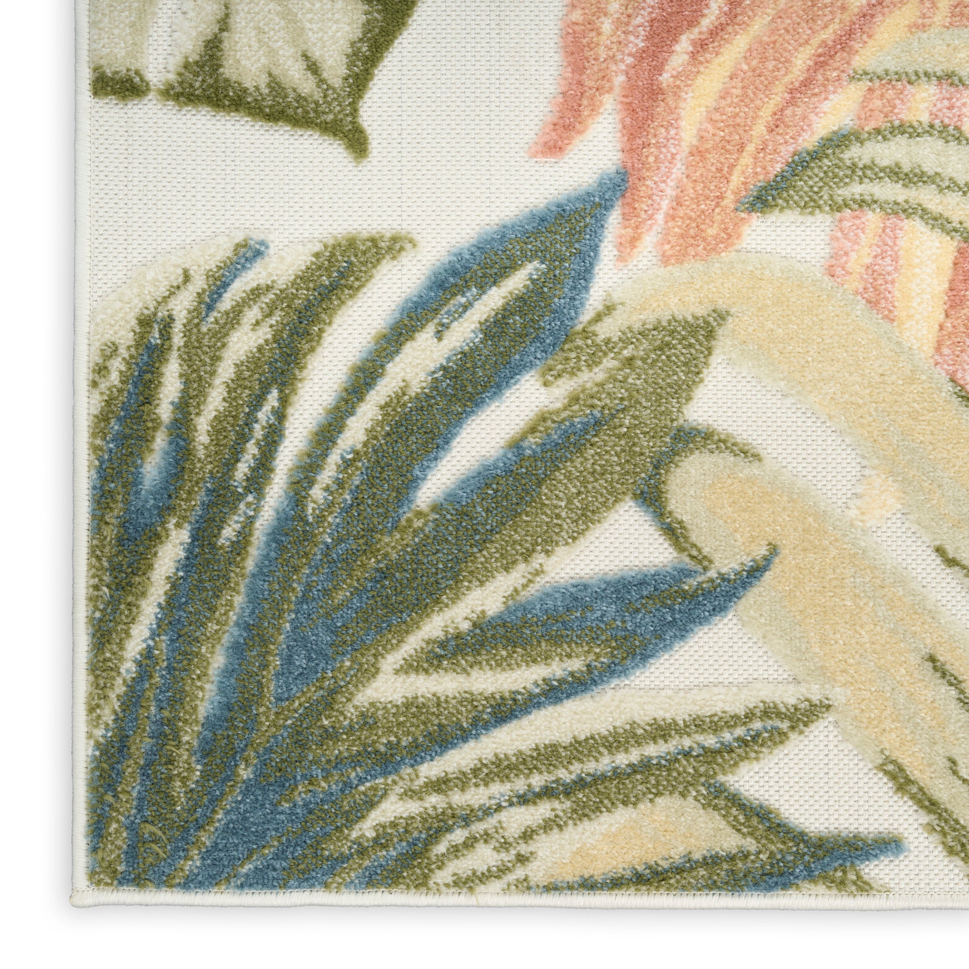Close-up of tropical leaf pattern on woven textile with blue, olive & beige leaves on cream background; edge seam visible.