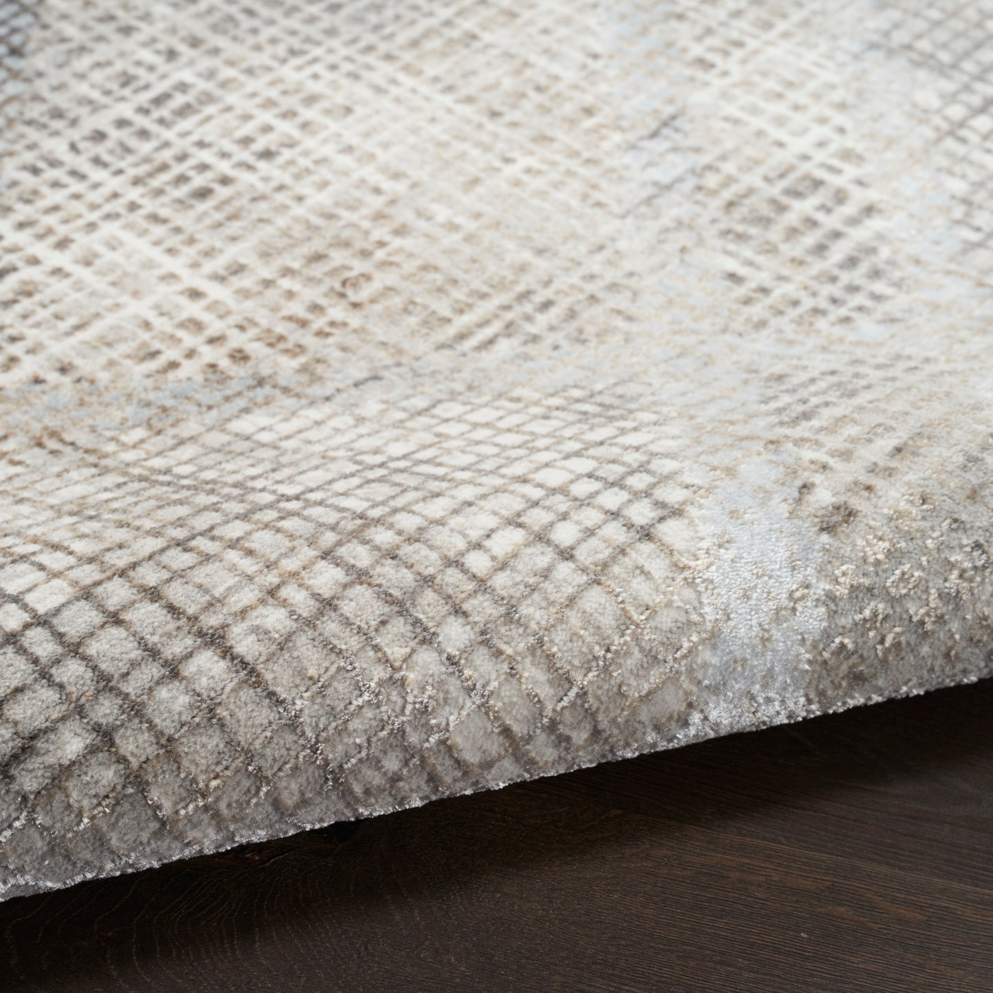 Beige ivory snakeskin-patterned area rug with plush pile and subtle diamond lattice texture.