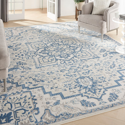 Blue and ivory oriental area rug with medallion center, intricate border, plush soft pile in living room.