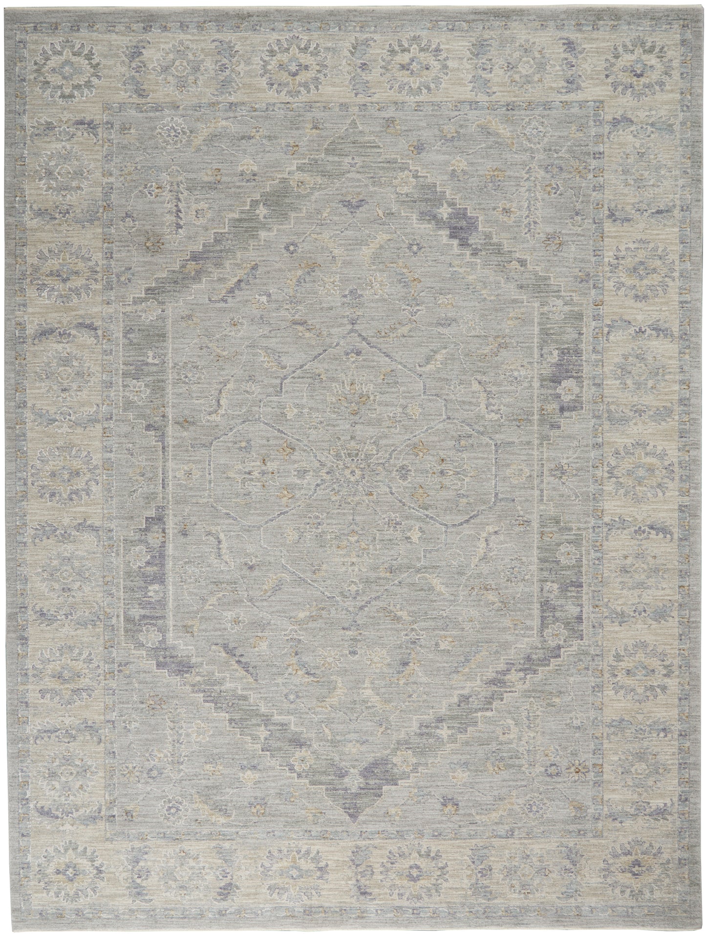 Soft gray-blue and beige oriental area rug with a faded central medallion and floral border.