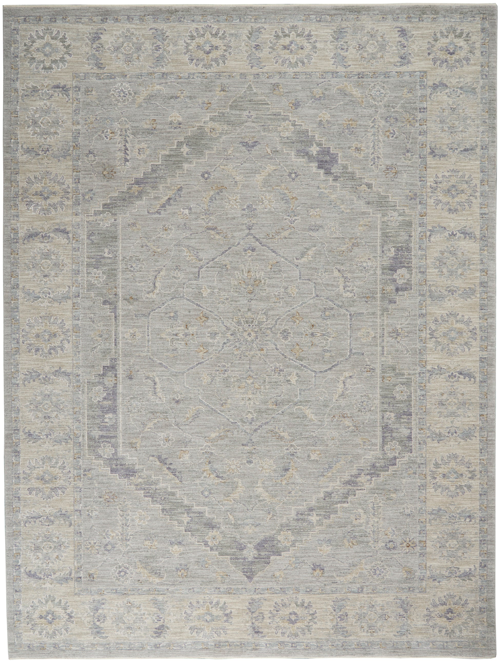Soft gray-blue and beige oriental area rug with a faded central medallion and floral border.