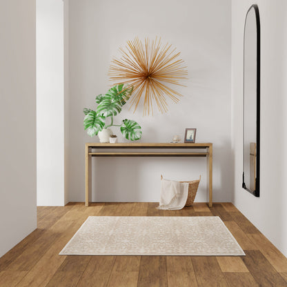 Minimalist entryway with wooden console, gold sunburst art, monstera plant, framed photo, beige rug, and arched mirror.