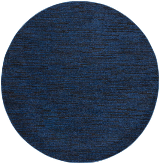 Dark blue round rug with heathered texture, soft woven fabric for living room or bedroom.