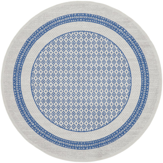 Round rug with blue diamond lattice center and double blue border on white background.