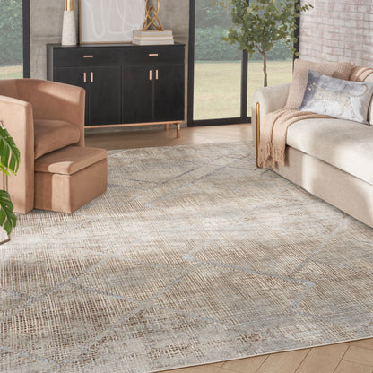 Neutral modern living room with a textured beige area rug, cream sofa, tan armchair, & black gold-accent sideboard.
