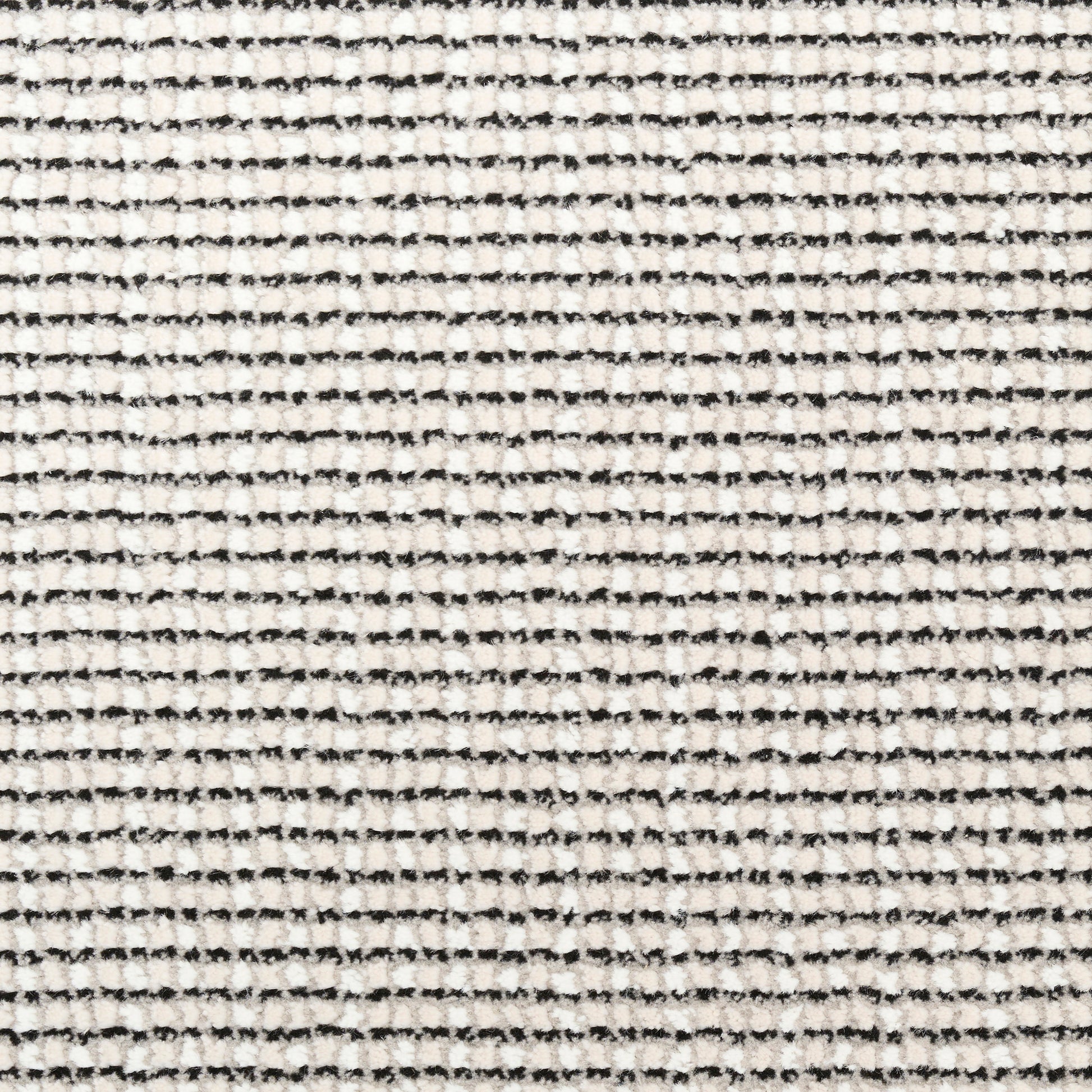 Cream rug with fine black horizontal specks and a textured weave.