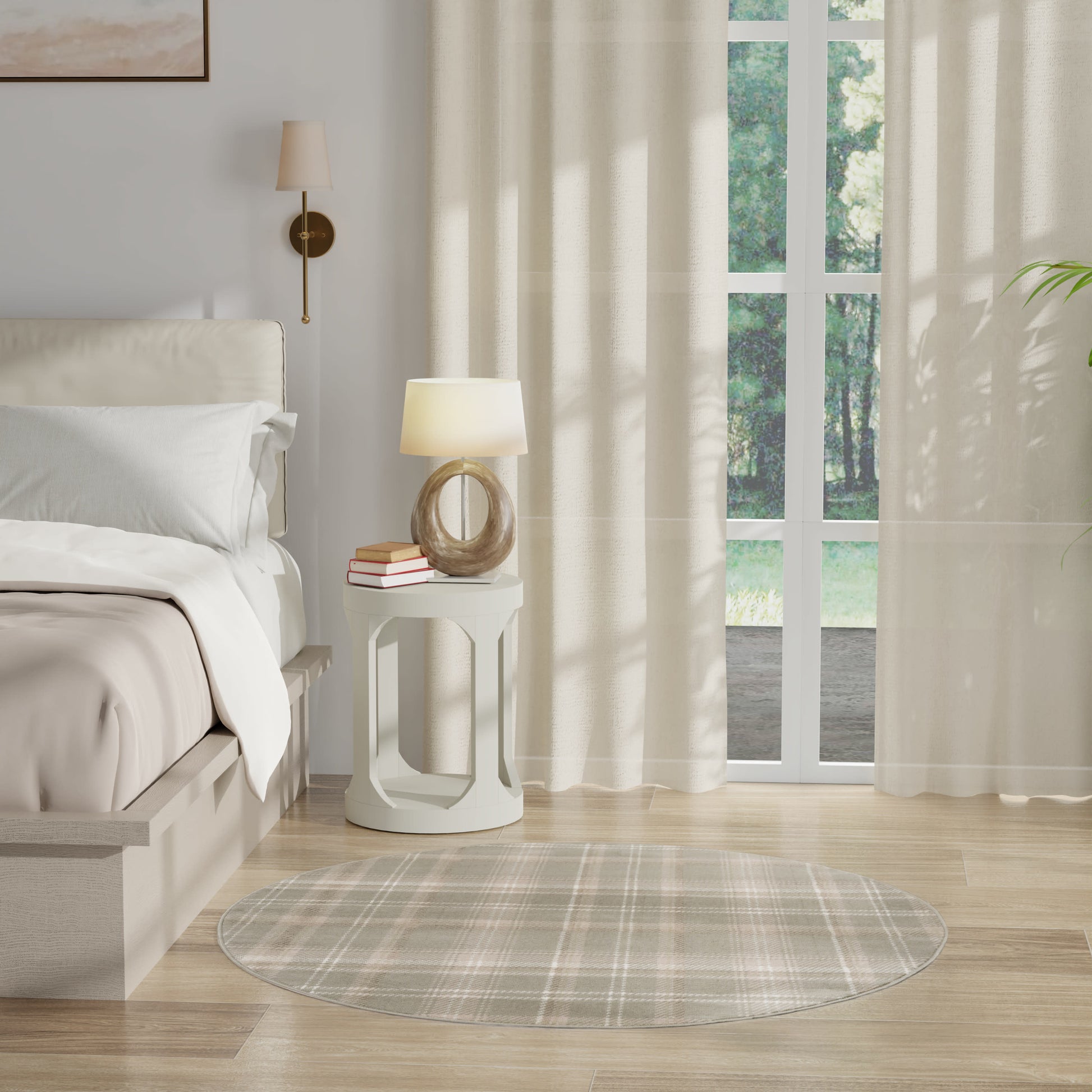 Neutral bedroom with a round white nightstand, sculptural lamp, plaid round rug, & sheer beige curtains by a large window.