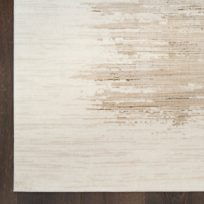 Cream area rug with a dark left border & light beige distressed brushstroke pattern, woven texture on wood floor.