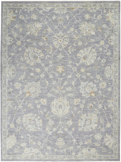 Blue-gray traditional floral area rug with ivory and beige blossoms; bordered, soft pile.