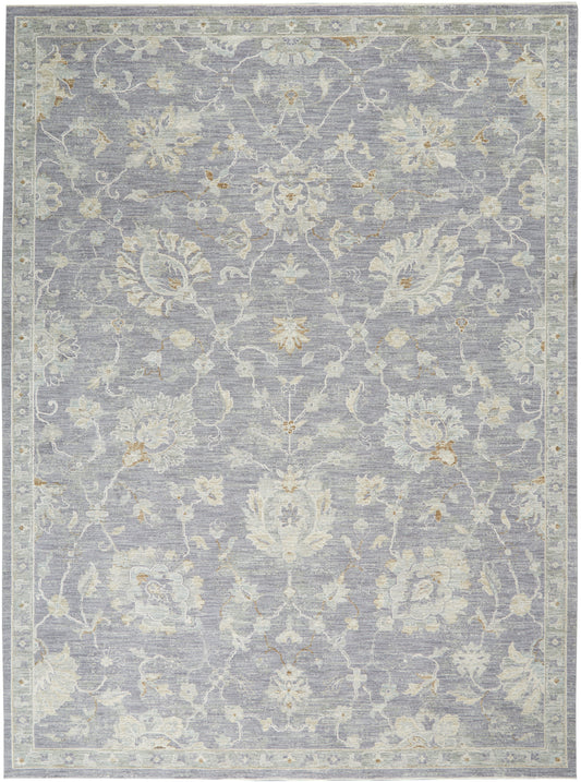 Blue-gray traditional floral area rug with ivory and beige blossoms; bordered, soft pile.