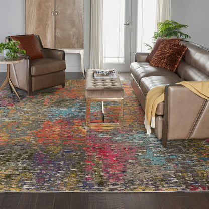 Cozy contemporary living room with brown leather sofa and armchairs, tufted beige ottoman, and a vibrant multicolor rug.