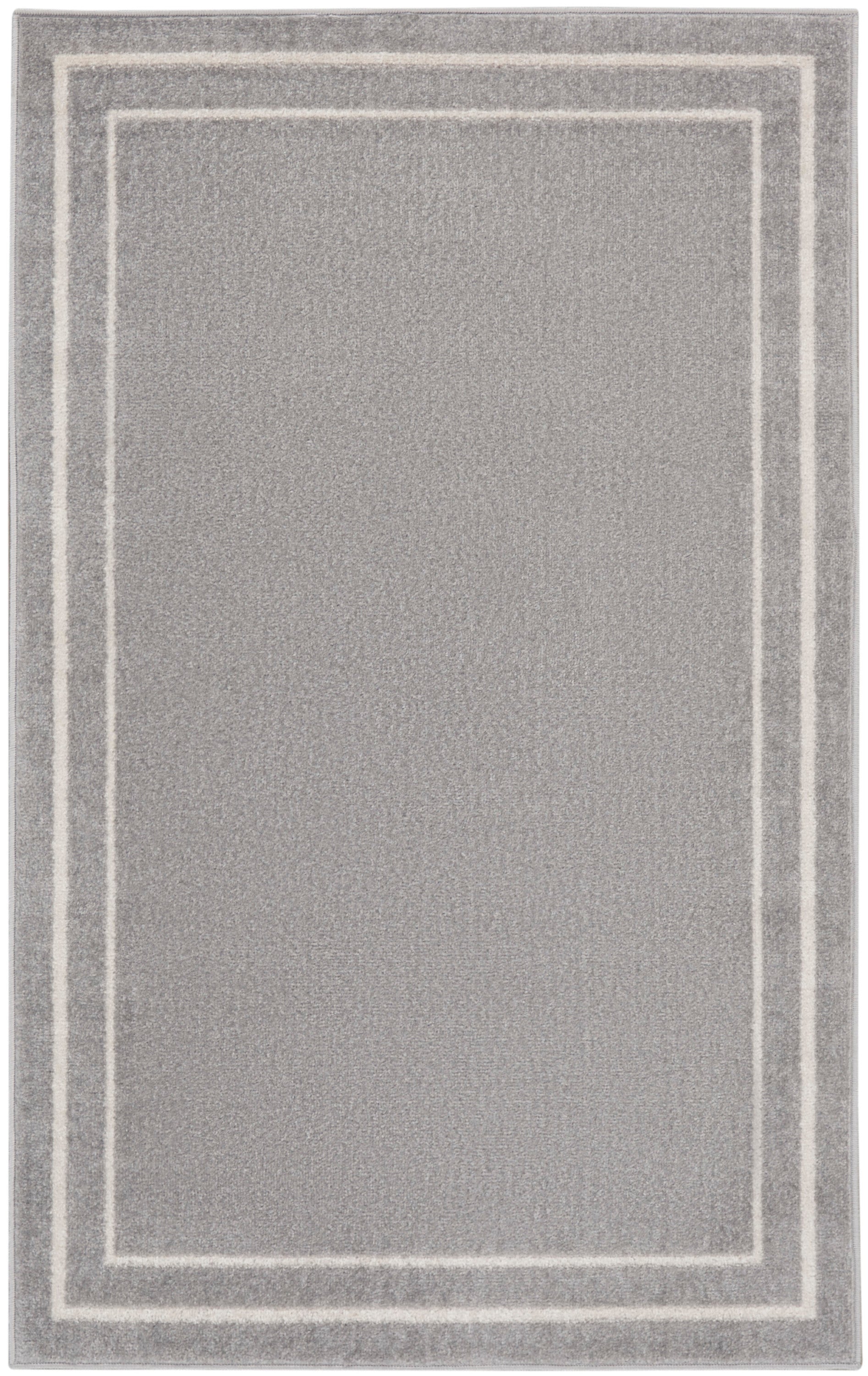 Soft gray plush area rug with double white rectangular borders framing the center.