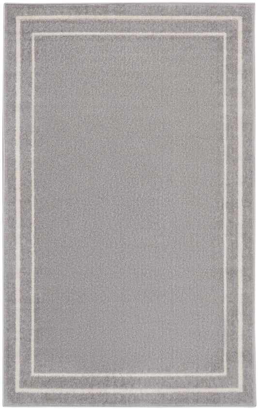 Soft gray plush area rug with double white rectangular borders framing the center.