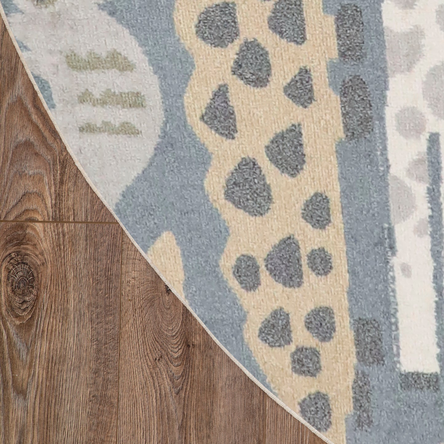 Blue and beige round area rug (8' round) with a grey spotted abstract pattern on dark hardwood floor.