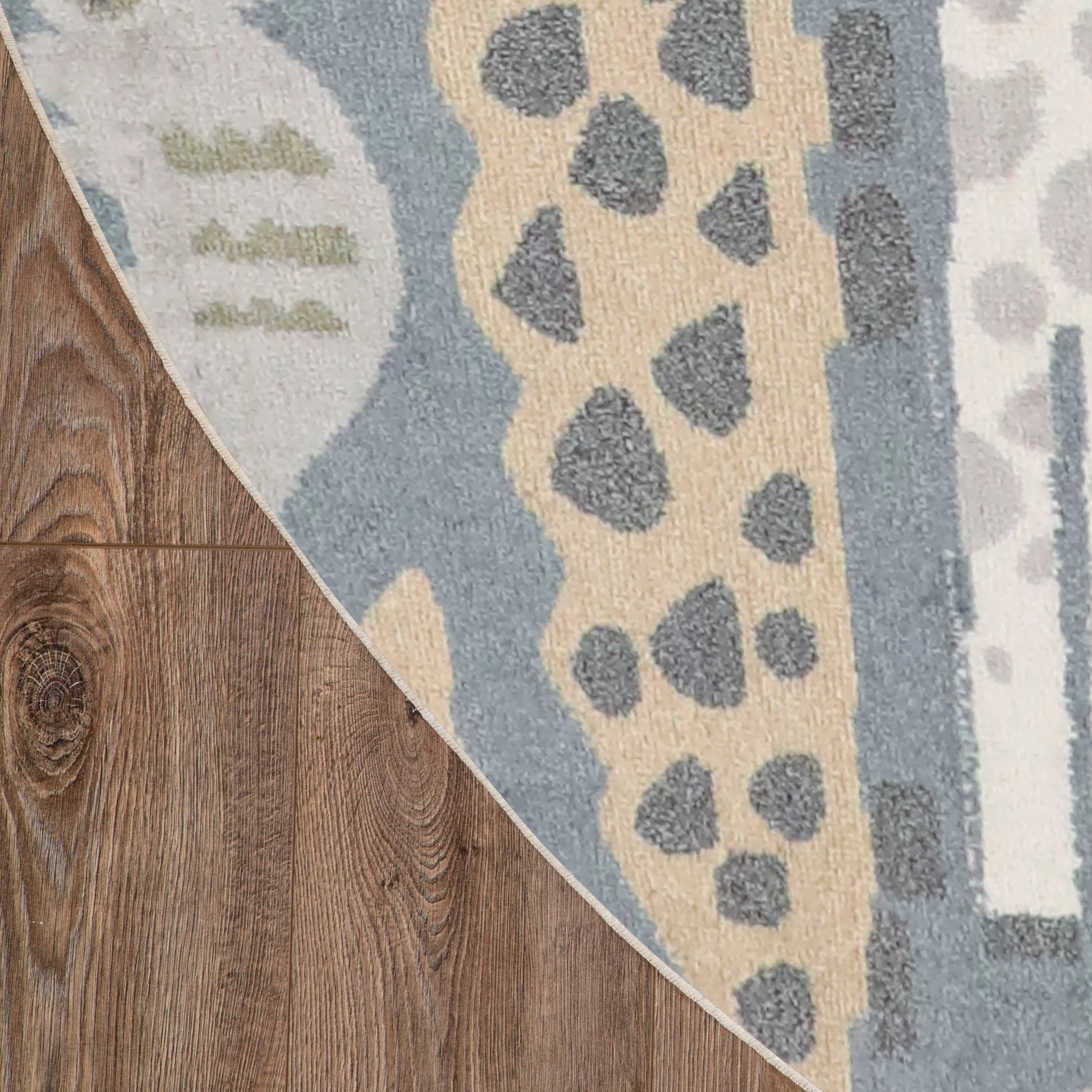 Blue and beige round area rug (8' round) with a grey spotted abstract pattern on dark hardwood floor.