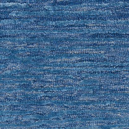 Blue textured rug with looped pile in denim tones; casual, cozy living room area rug.