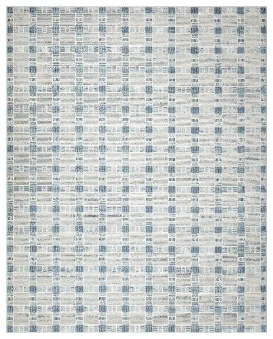 Blue and cream patchwork rug with a geometric grid of small rectangular blocks.