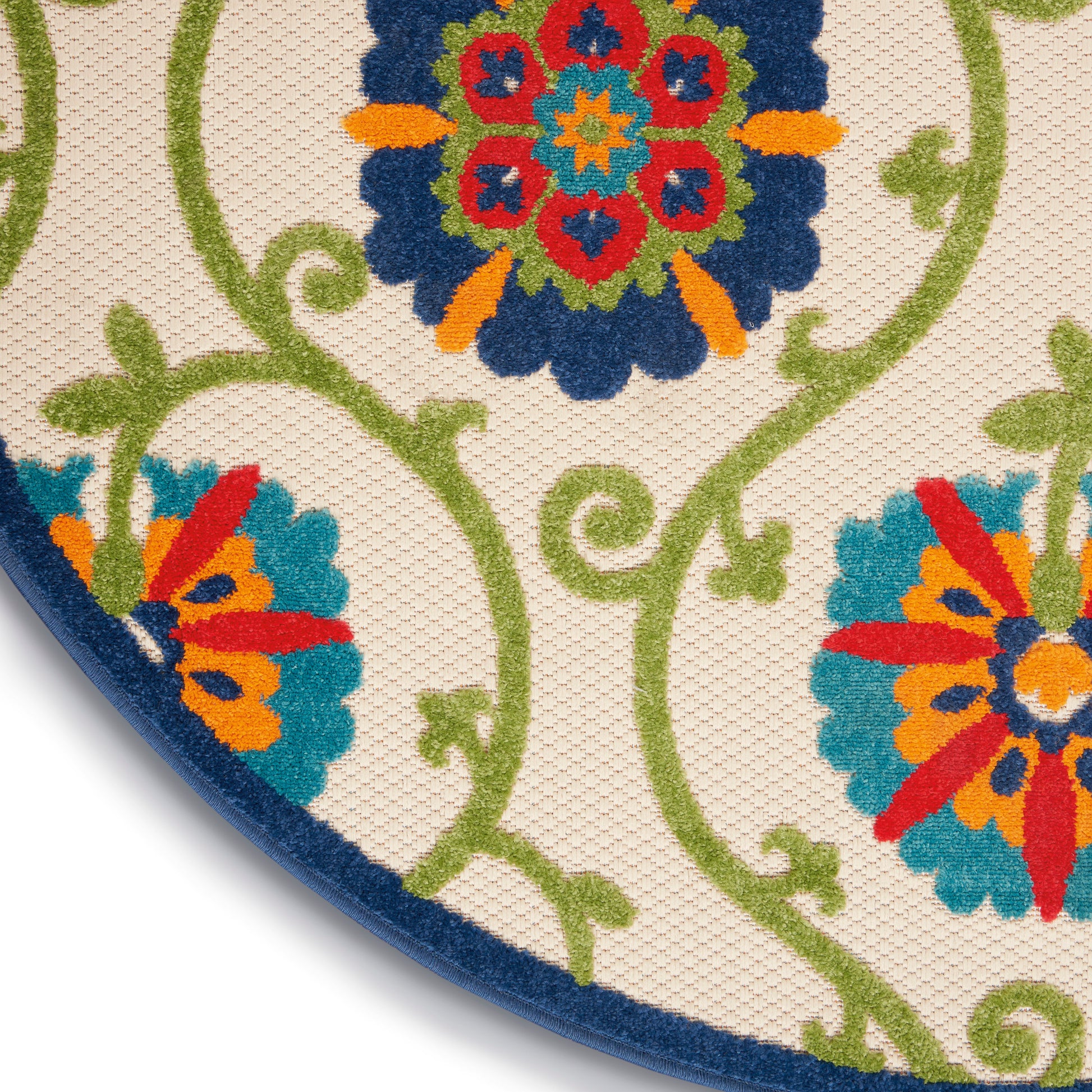 Round decorative rug with vivid multicolor floral medallions and green scrolling vines on beige, navy border.