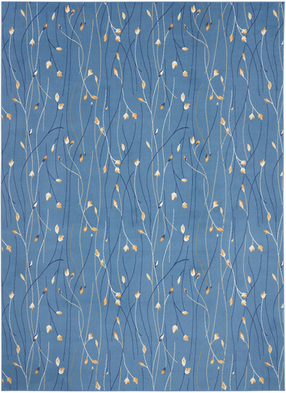 Blue textile with slender white stems and tiny golden leaves creating a delicate vine pattern.