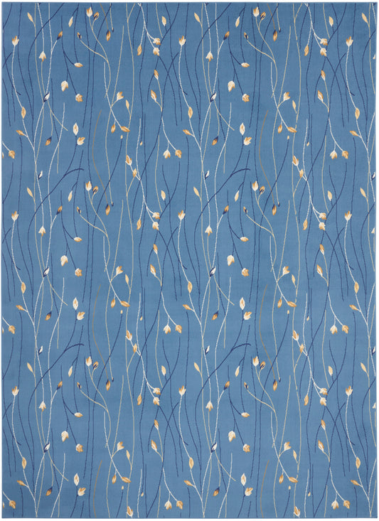 Blue textile with slender white stems and tiny golden leaves creating a delicate vine pattern.