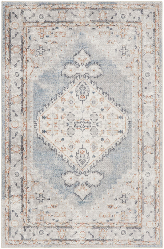 Rectangular vintage-inspired area rug in pale blue and ivory with a central diamond medallion and distressed border