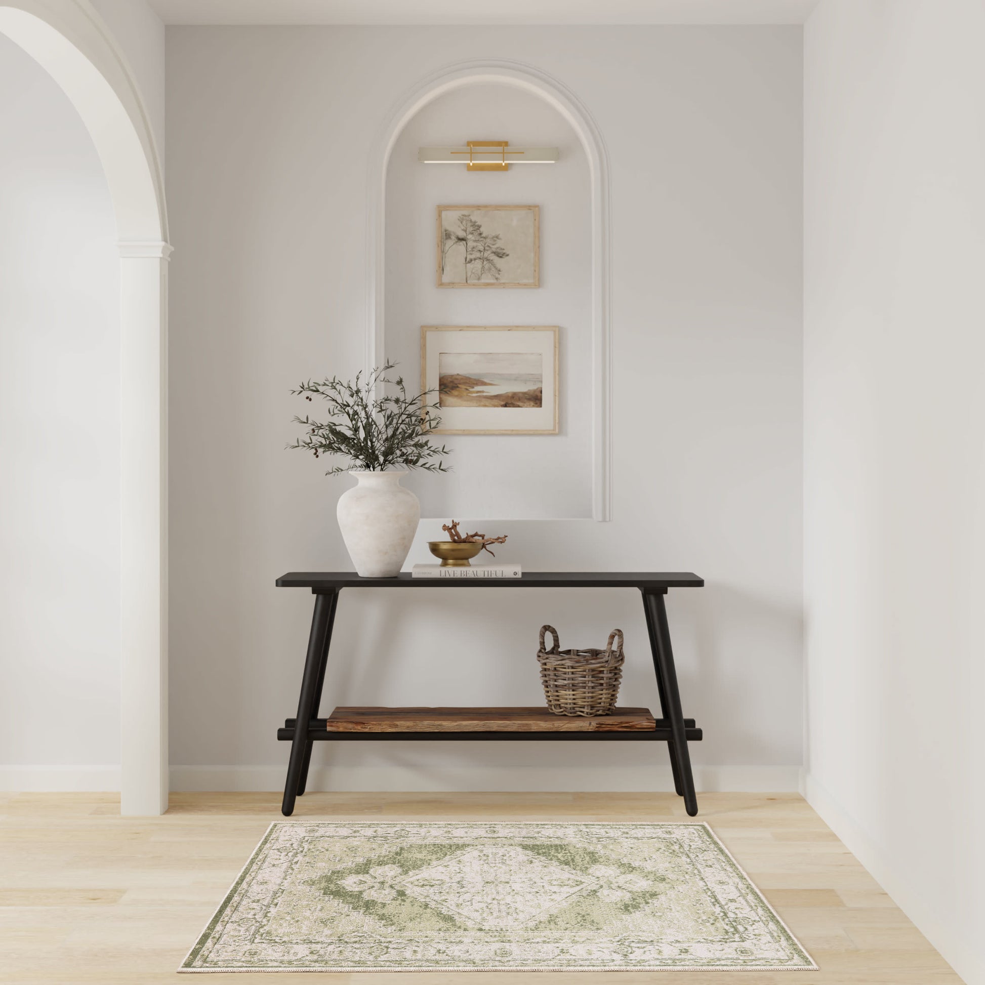 Green rug in a pale arched alcove with a dark wood console and decor items (vase, greenery, brass bowl, books, basket).
